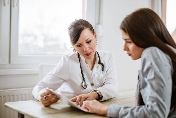 a woman talking with a doctor
