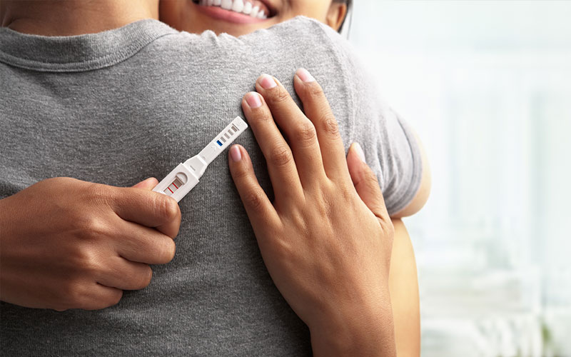 Happy Couple With Positive Pregnancy Test.